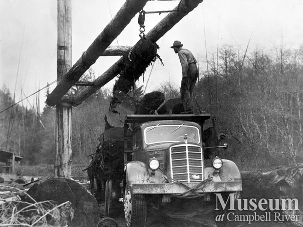 Logging truck being loaded at Fulmore Lake, Port Neville