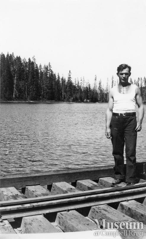 Don Brosseau on railroad track at Elk River Timber Co. camp