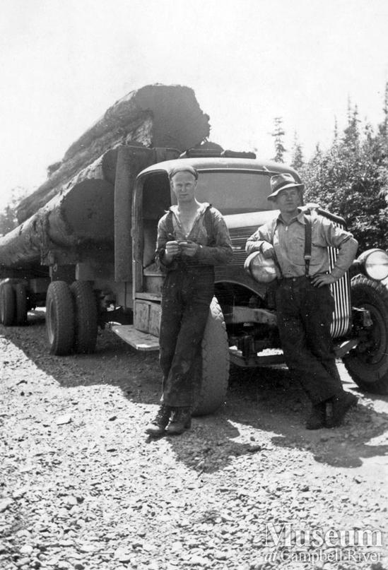 Loggers in front of loaded logging truck near Port Neville