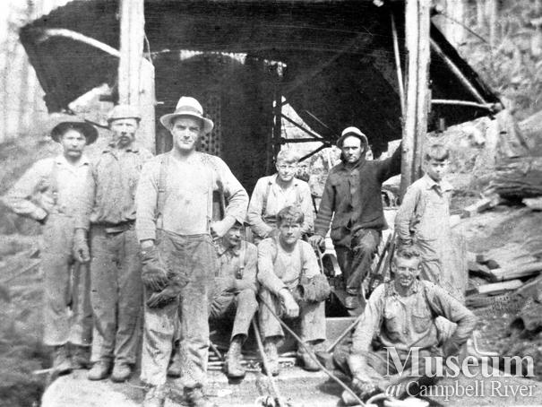 Bendickson Logging crew in front of a steam donkey