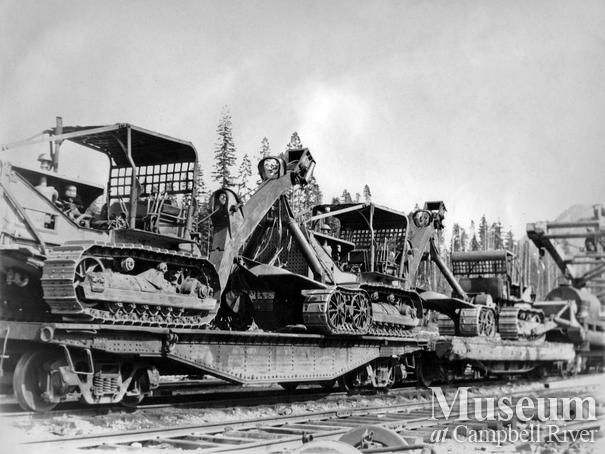 Cat Tractors and Mill Boom on Bull Cars at Woss